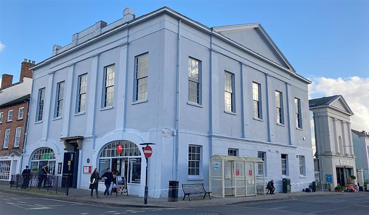 Large stucco building painted grey