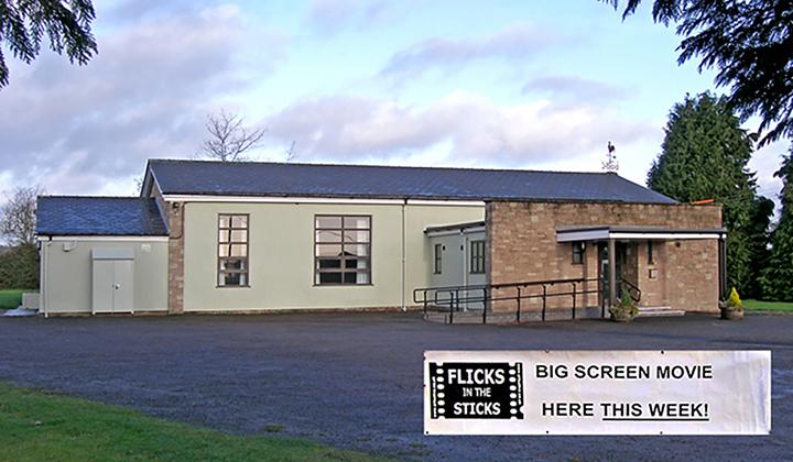 Light green and brick village hall with Flicks in the Sticks sign