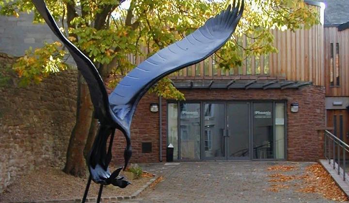 Modern glass-fronted theatre in leafy environment