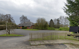 Driveway with modern brick village Hal visible in the distance