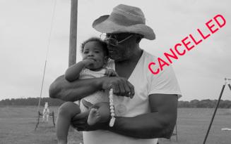 Elderly black man in straw hat and white T shirt carrying baby. Red text reading CANCELLED. 